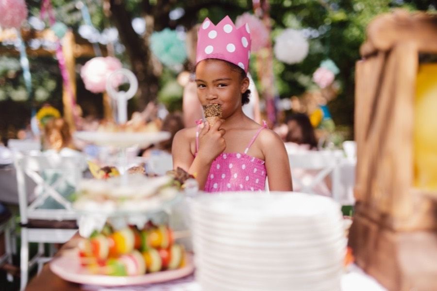 Child in a party crown at an outdoor children’s birthday party